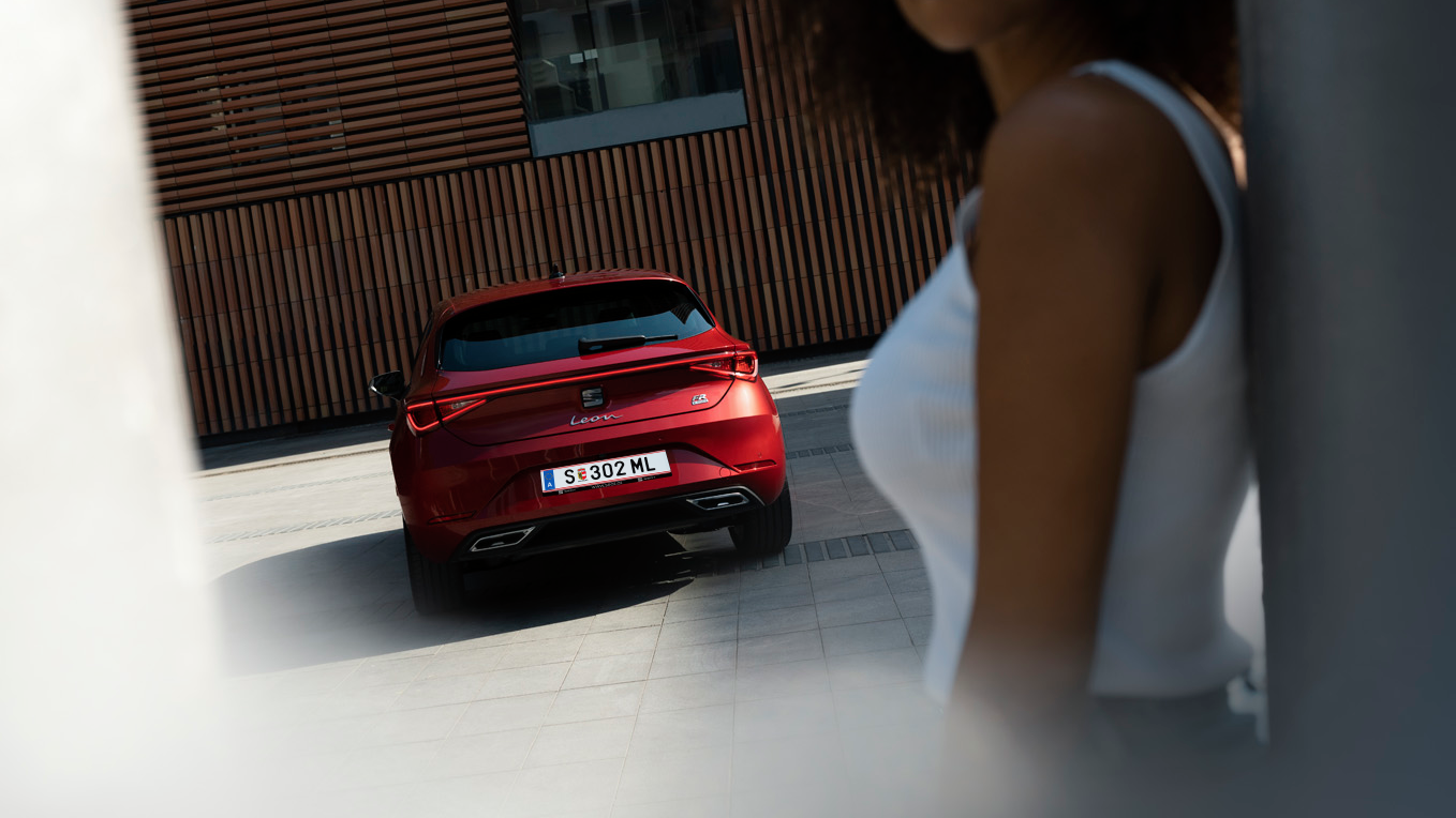 Frau steht vor dem SEAT Leon